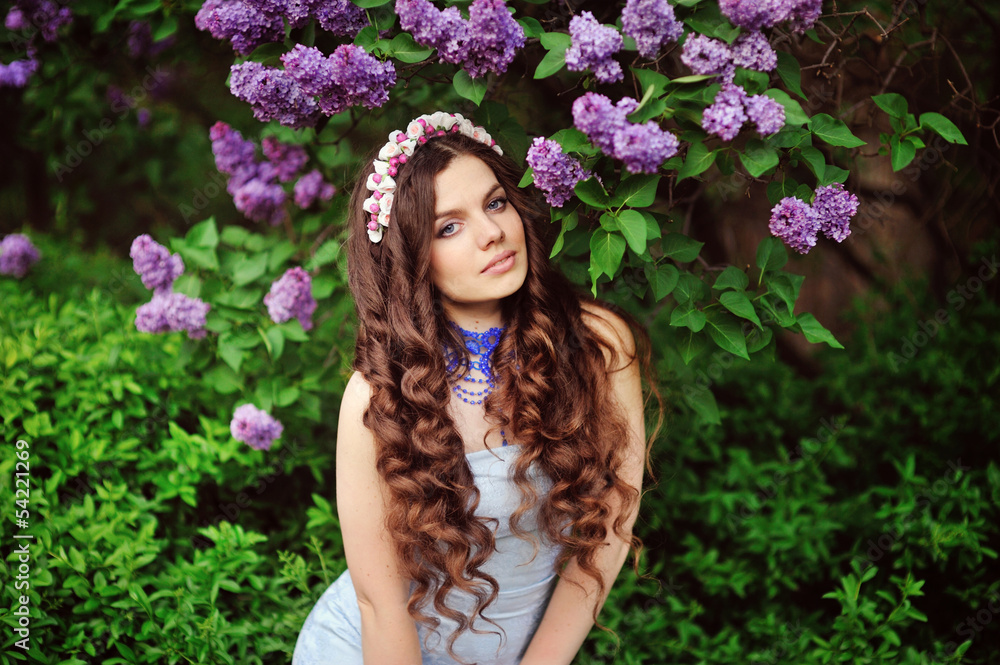 Beautiful young woman in lilac flowers, outdoors portrait Beautiful young woman in lilac flowers, outdoors portrait