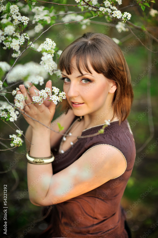 beautiful young brunette woman standing near tree beautiful young brunette woman standing near tree