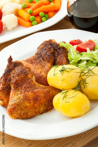 Roasted chicken wings with young potatoes