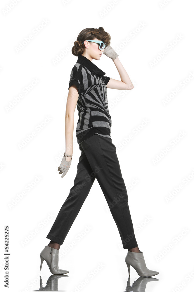 young fashion model in gloves with sunglasses walking young fashion model in gloves with sunglasses walking