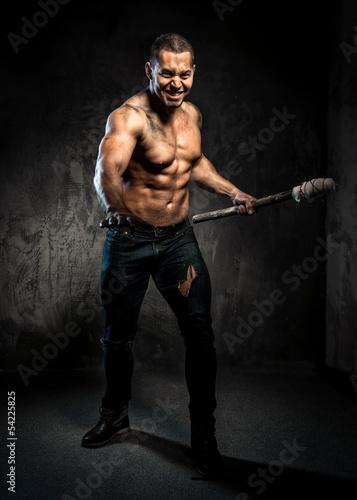 Muscular man holding torch photo