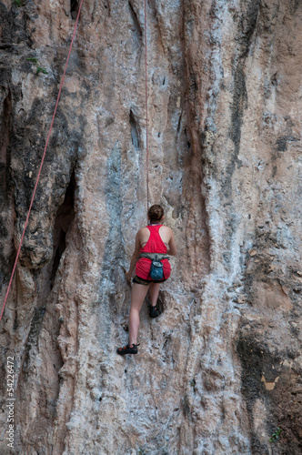 Woman climbing on the rock route summer (Railay Beach, Krabi pro