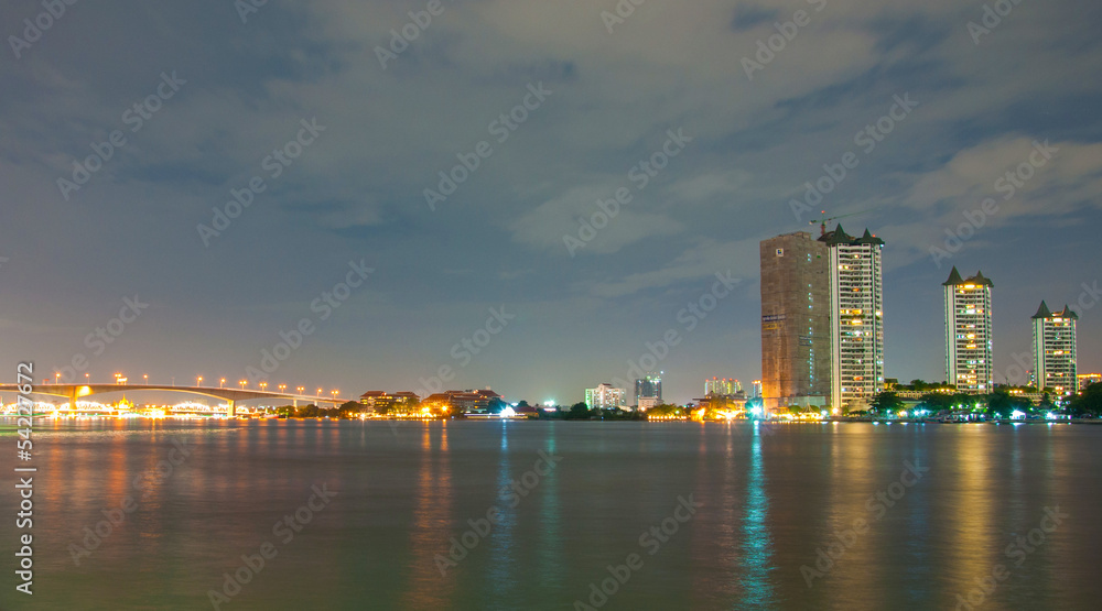 Fototapeta premium city downtown at night with building reflection in the river Ban