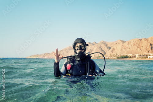 female diver shows a sign okay