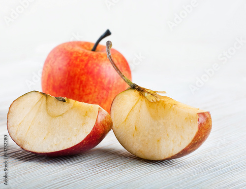 Slices of ripe apples on a wooden table