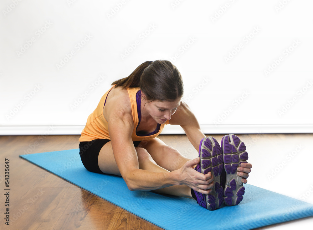 Fit woman stretching before a workout Fit woman stretching before a workout
