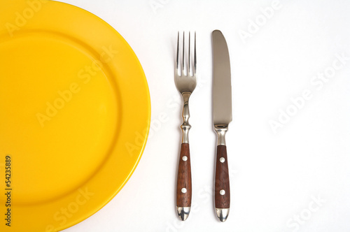 Cutlery and plate isolated with white background photo