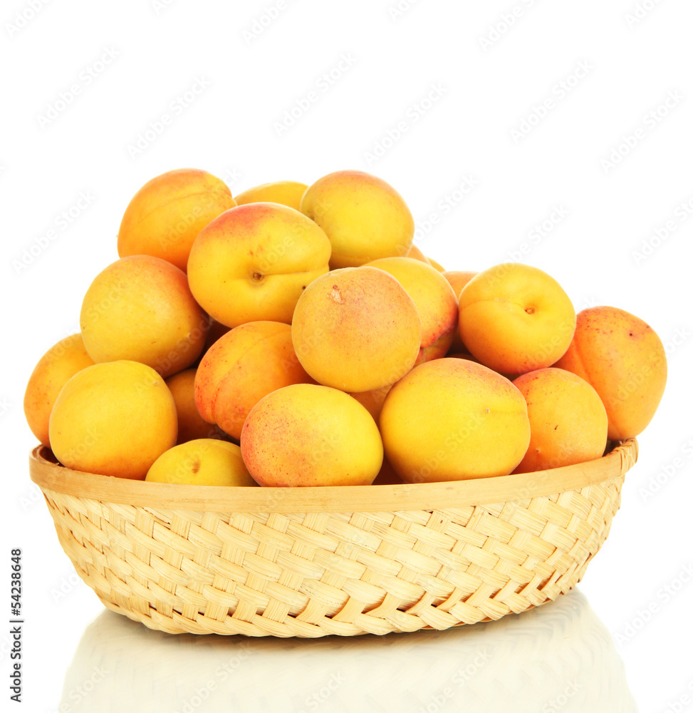 Fresh natural apricot in wicker basket isolated on white Fresh natural apricot in wicker basket isolated on white