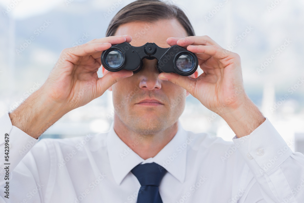Close up of businessman using binoculars Close up of businessman using binoculars