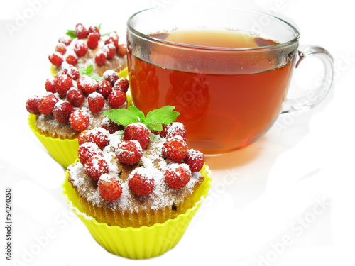 muffin cakes with wild strawberry berries and tea photo