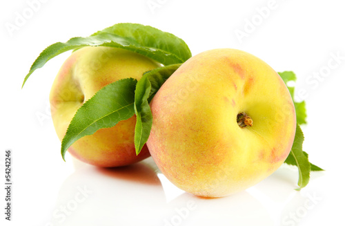 Ripe sweet peaches with leaves, isolated on white