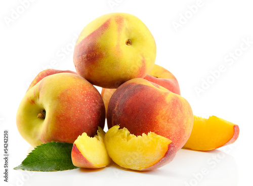 Ripe sweet peaches with leaves, isolated on white