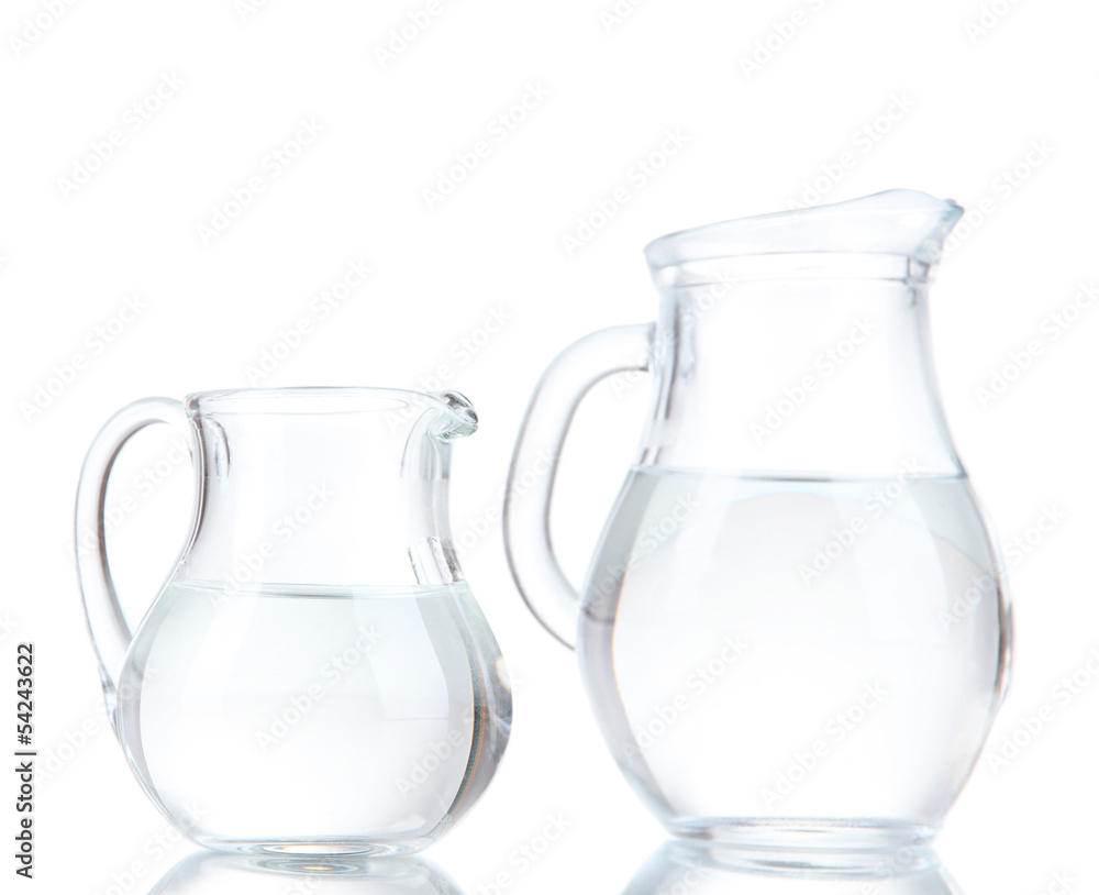 Glass pitchers of water isolated on white