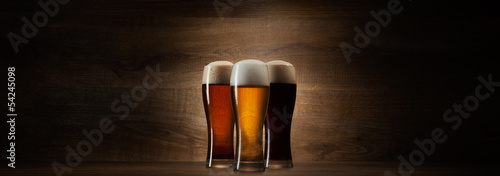 tree glass beer on wood background with copyspace