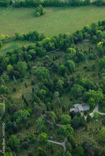 Aerial view of a cemetery with tomb and green trees.