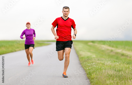 Couple running on country road © blas