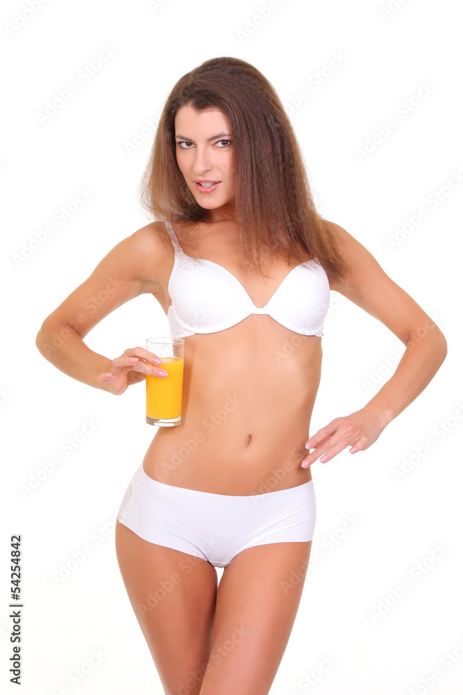 Girl with a beautiful figure holding a glass of juice Girl with a beautiful figure holding a glass of juice