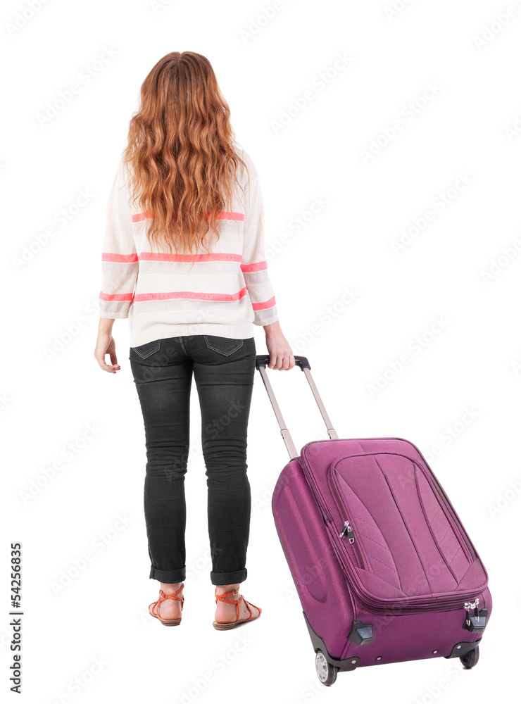 back view of walking woman with suitcase. back view of walking woman with suitcase.