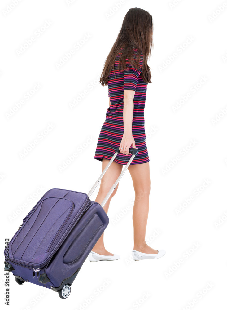 back view of walking woman with green suitcase back view of walking woman with green suitcase