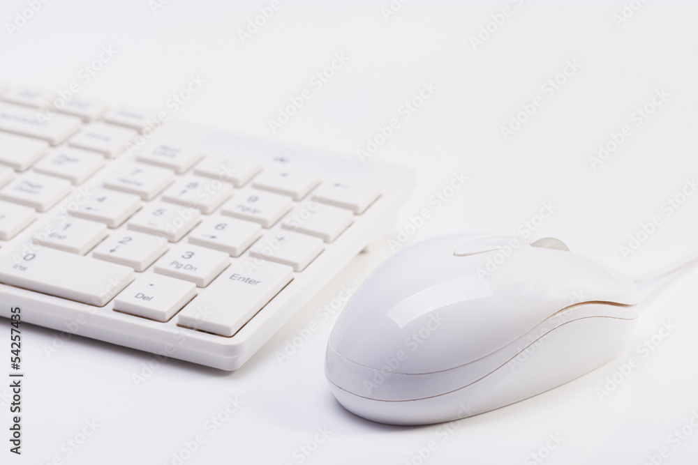 Close up of white wireless keyboard and wired mouse Close up of white wireless keyboard and wired mouse