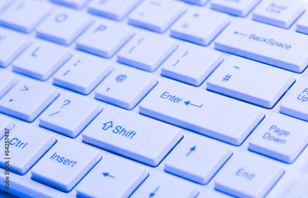 Close up of white keyboard with blue lighting effect Close up of white keyboard with blue lighting effect