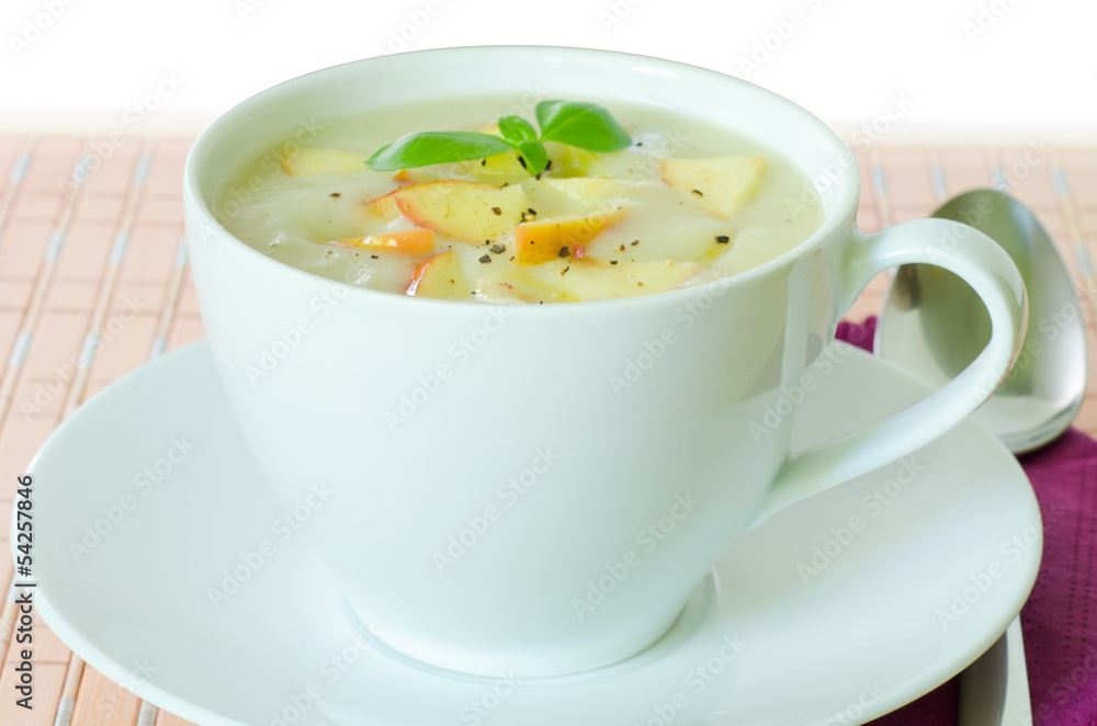 Closeup on a cup with potato and apple soup Closeup on a cup with potato and apple soup