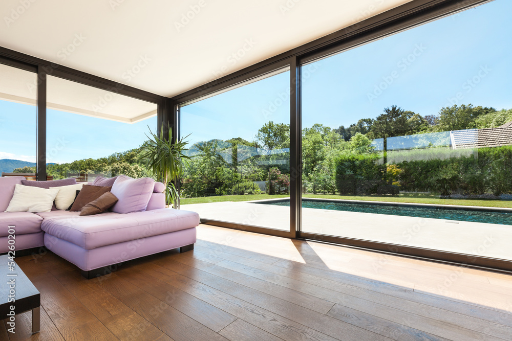 Fototapeta premium Modern villa, interior, wide living room with pink divan