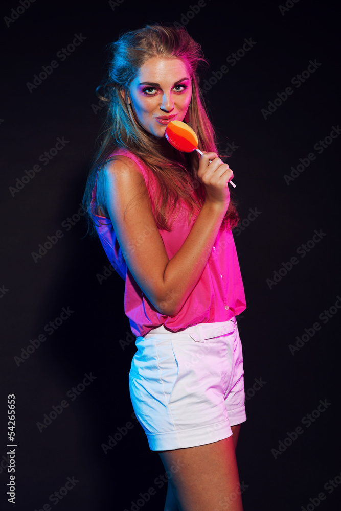 Retro 80s fashion disco girl with blonde hair and lollipop. Blac