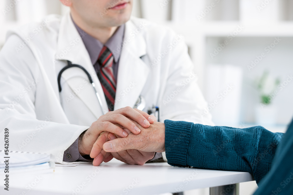 Doctor holding patient's hand Doctor holding patient's hand