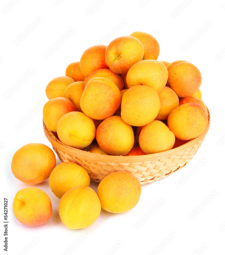 Fresh natural apricot in wicker basket isolated on white Fresh natural apricot in wicker basket isolated on white