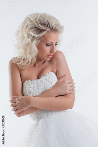Shy beautiful bride posing in studio, close-up