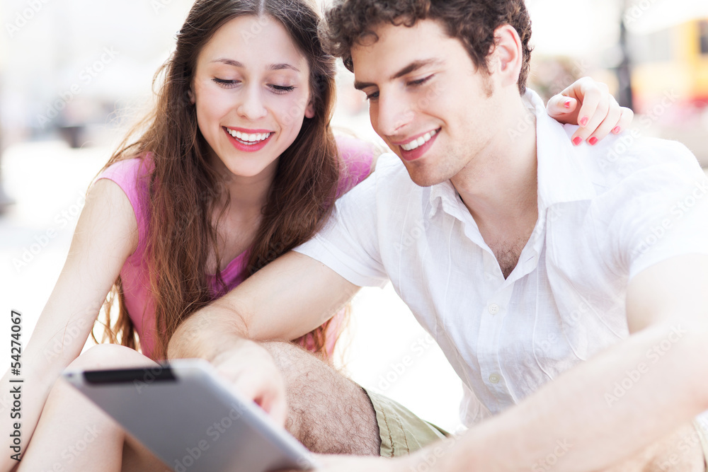 Fototapeta premium Young people looking at digital tablet