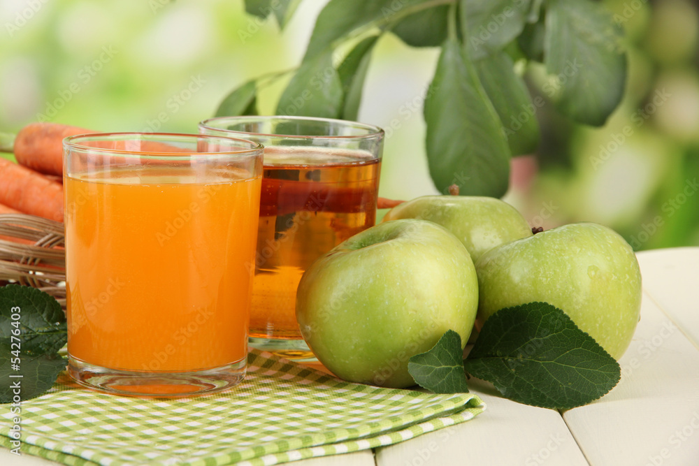 Glasses of juice, apples and carrots Glasses of juice, apples and carrots