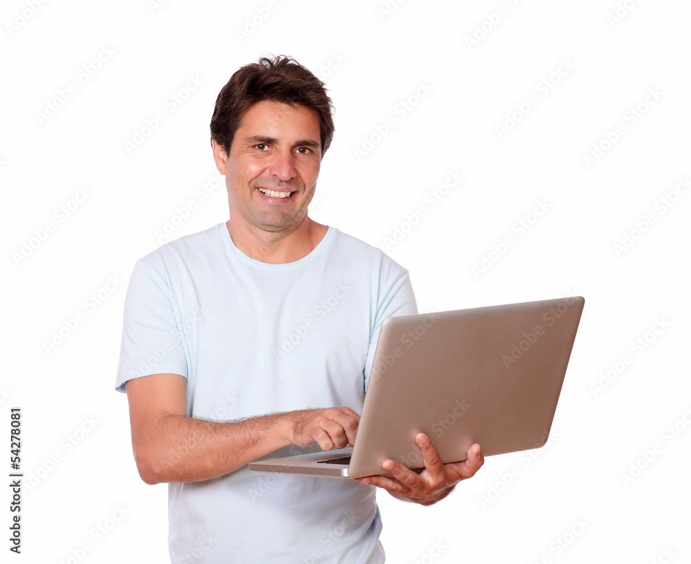Charming male working on laptop while standing Charming male working on laptop while standing