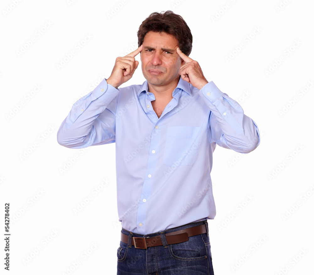 Tired adult man standing with a tension headache Tired adult man standing with a tension headache