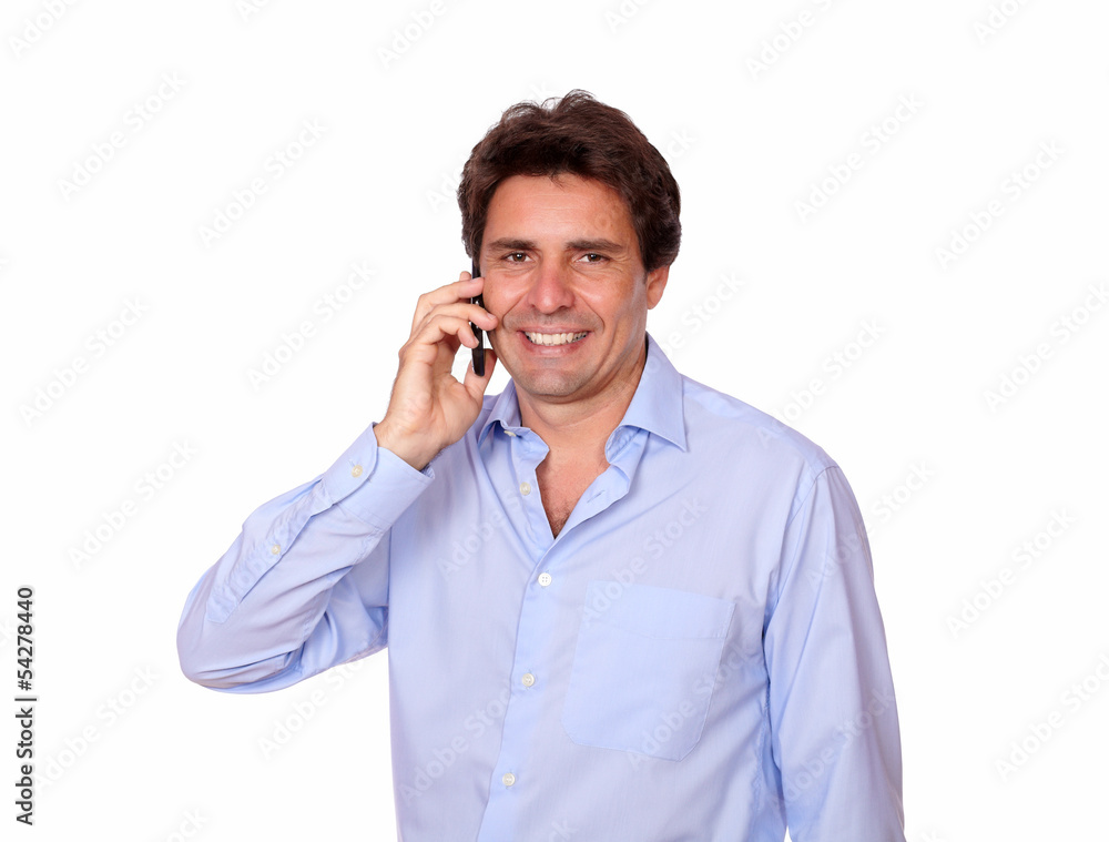 Smiling adult man speaking on cellphone Smiling adult man speaking on cellphone