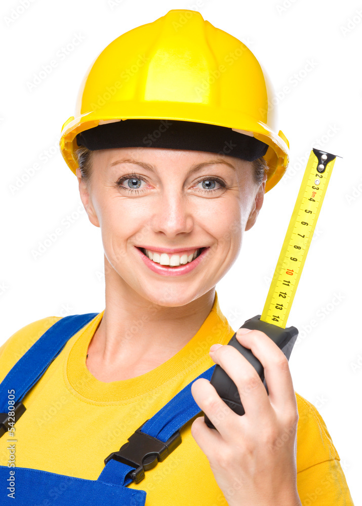 Young construction worker with tape measure