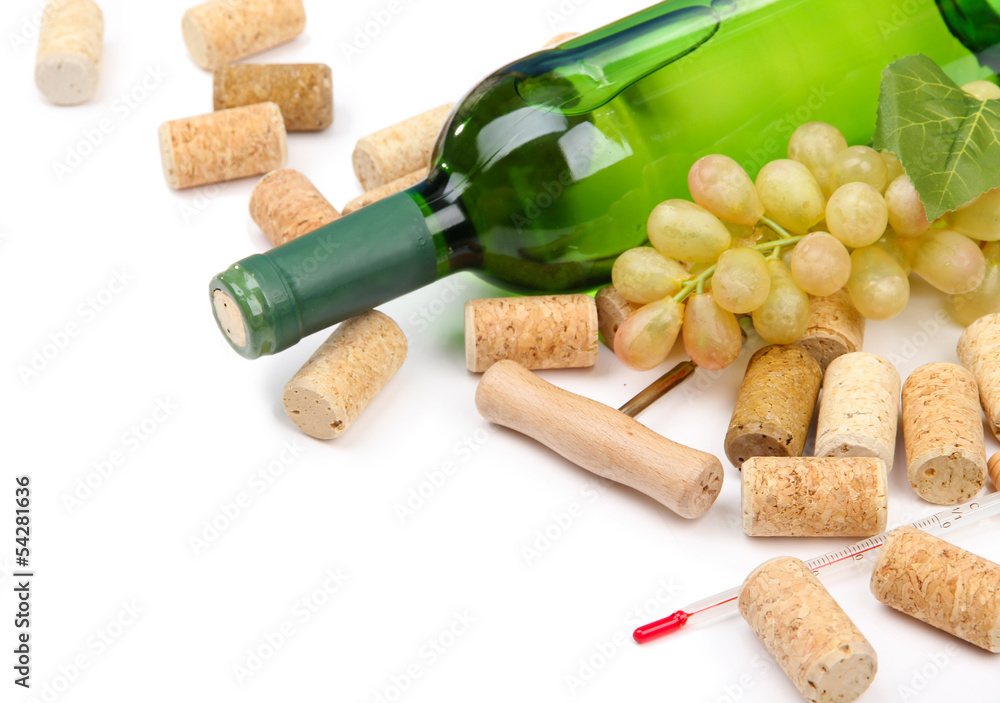 Bottle of wine, grapes and corks, isolated on white
