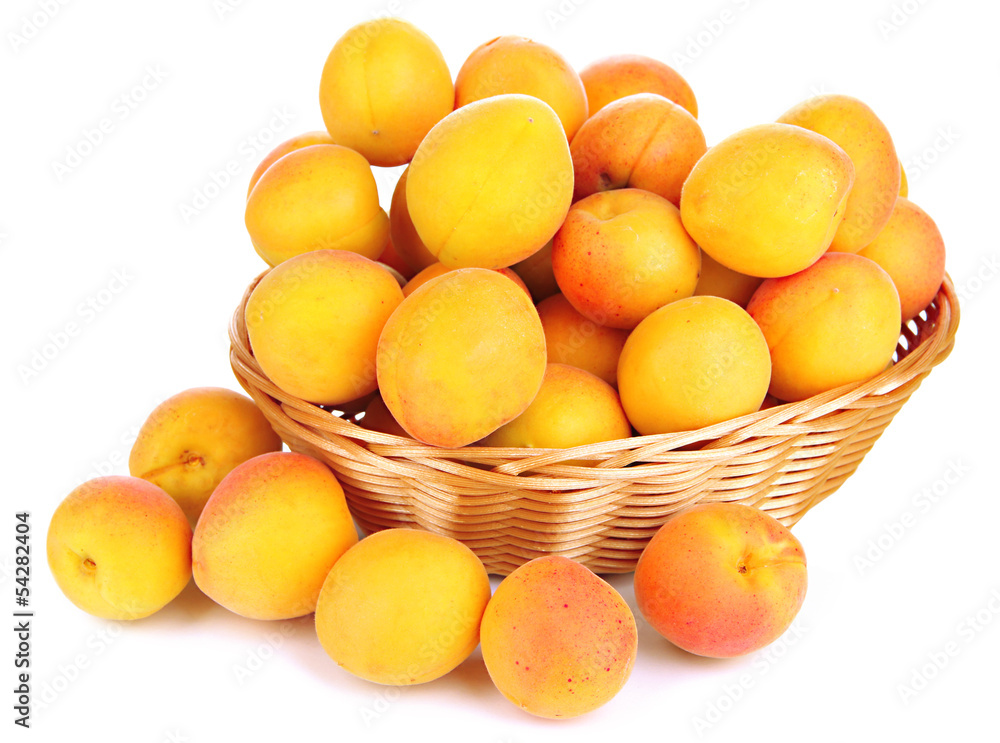 Fresh natural apricot in wicker basket isolated on white