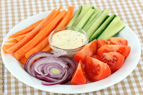 Assorted raw vegetables sticks in plate on table close up