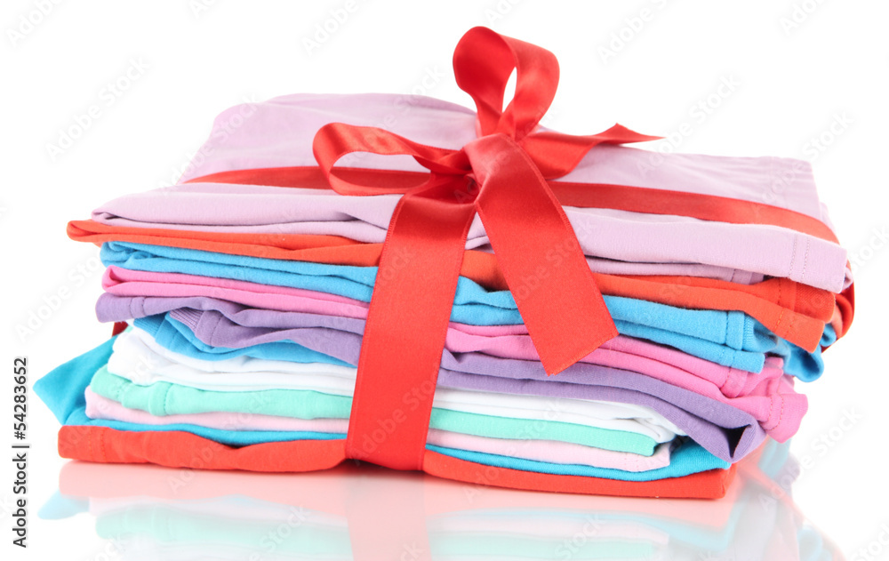 Pile of clothing with red ribbon and bow isolated on white Pile of clothing with red ribbon and bow isolated on white