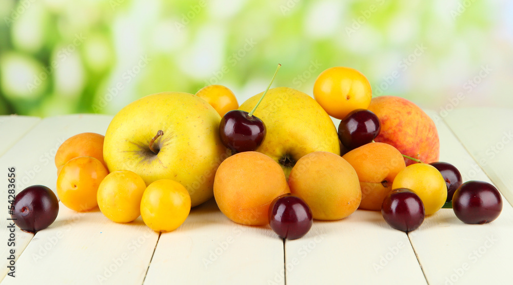 Bright summer fruits on wooden table on natural background Bright summer fruits on wooden table on natural background