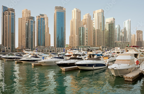 Luxurious Yachts and Boats in Front of Dubai Marina Skyscrapers © Borna_Mir