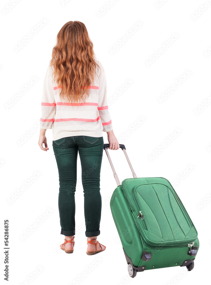 back view of walking woman with suitcase. back view of walking woman with suitcase.