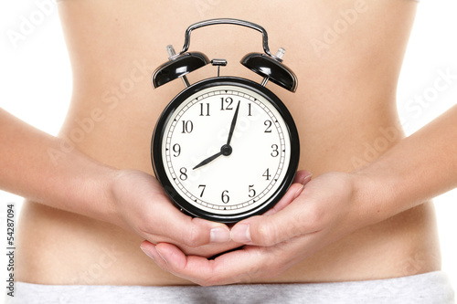 Biological clock ticking - woman holding watch photo