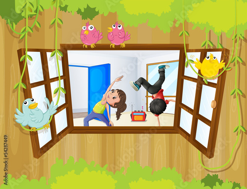 A girl and a boy exercising inside a room with birds at the wind
