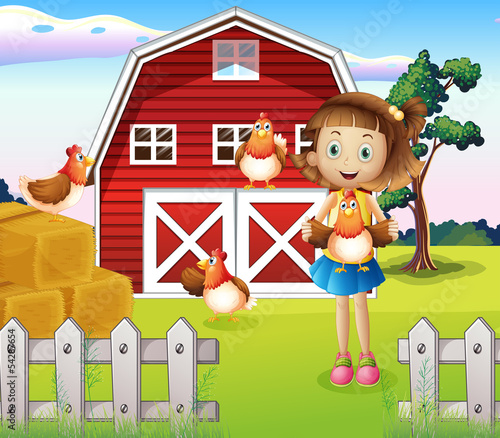 A girl holding a chicken at the farm