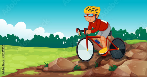 A boy biking at the rocky road