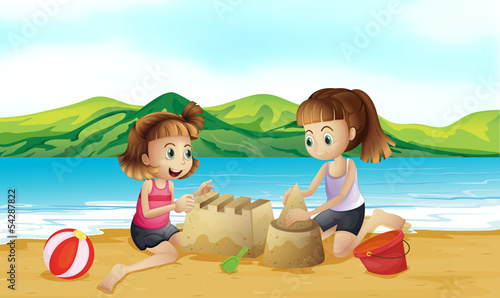 Two friends making a castle at the beach