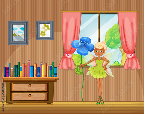 A fairy holding a flower inside the house